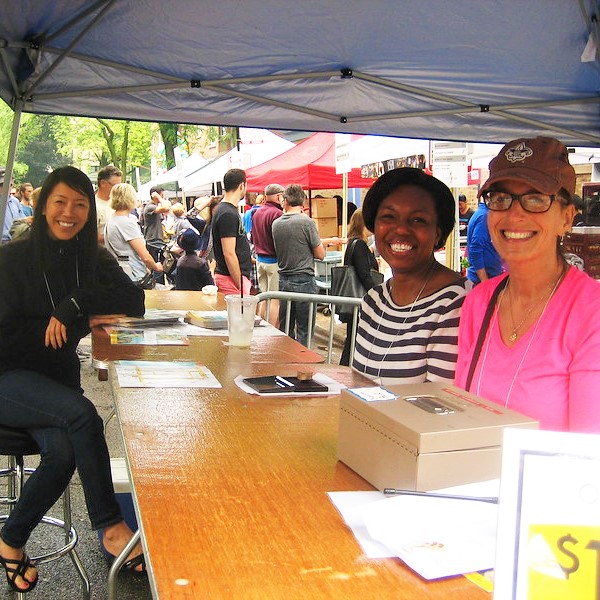 Three women sitting at a booth